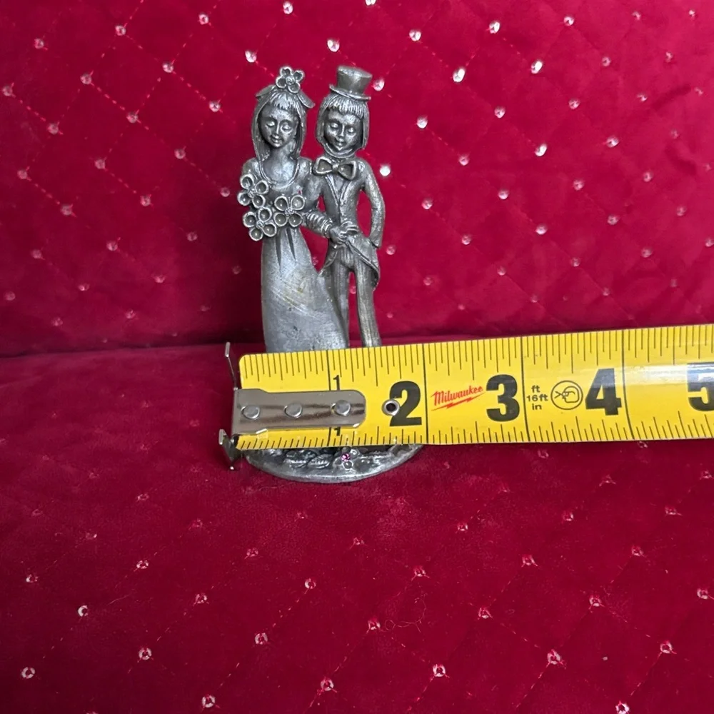 This is a vintage Italian Peltro pewter bride and groom figurine.